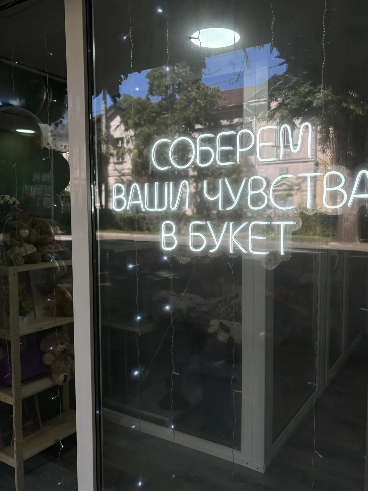 Неоновая вывеска в витрине магазина: «Соберём ваши чувства в букет»